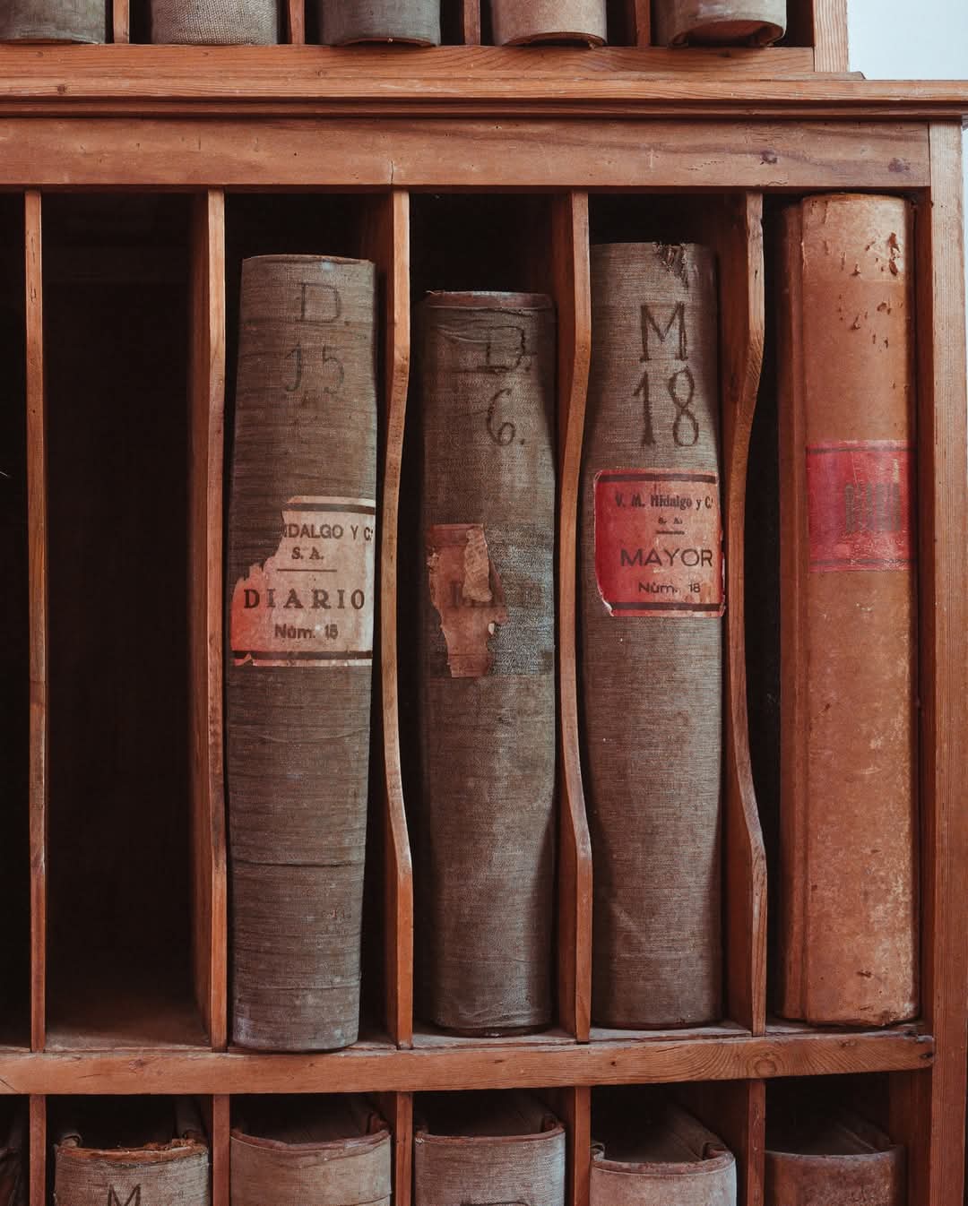 Historic Hidalgo y Cía accounting ledgers on wooden shelves in the bodega archive